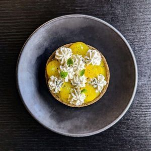 Lemon curd tart with whipped coconut cream and lemon gel, gluten free option available at Green Man's Arms in Carlton