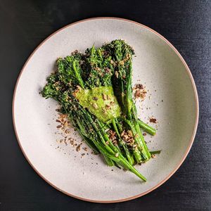 Sautéed greens in garlic-infused oil, topped with rich green goddess butter, crispy focaccia crumb, and GF anchovies at Green Man's Arms in Carlton