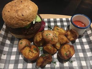 Vegan Burger. Bun, potatoes, patty & side sauce could all be better.  at Green Man's Arms in Carlton