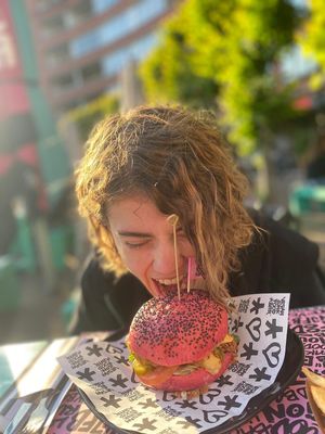 Me ATTACKING this amazing burger at Vegan Junk Food Bar - De Pijp in Amsterdam