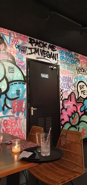 Inside decor; graffiti wall at Vegan Junk Food Bar - De Pijp in Amsterdam