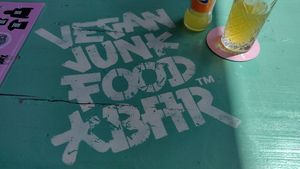 Bright outdoor tables at Vegan Junk Food Bar - De Pijp in Amsterdam