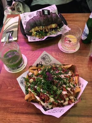 loaded fries + hot dog in a black croissant, how rad is that?! at Vegan Junk Food Bar - De Pijp in Amsterdam