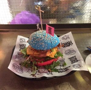 Burger with vegan chicken, cheese, bacon, lettuce, tomato and pickles.  at Vegan Junk Food Bar - De Pijp in Amsterdam