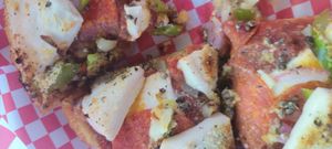 Deep dish pizza with homemade toppings at The Pizza Patio in Flagstaff