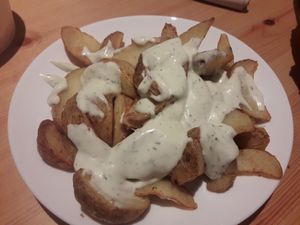 Potato wedges with dill sauce at Krowarzywa in Gdansk
