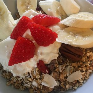 Homemade Granola served with Dairy free yogurt, oat milk and fresh fruit.  at True Story in York