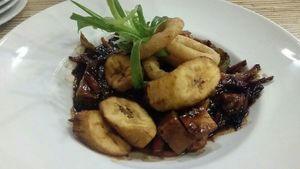 Jackfruit, Pineapple, Sweet Potato , Peppers stir fry in a soya and black bean sauce  with Plantain and Onion rings at Kool Runnings in Inverness