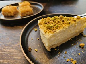 Baklava in background (all vegan, walnut, peanut and cashew (?) Flavour) and vegan pistachio cheesecake at Marrakech Artisan in Hastings