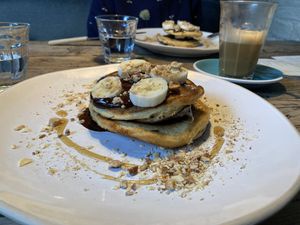 Plant-based pancakes with nuts, dark choc sauce and banana at The Old Bicycle Shop in Cambridge