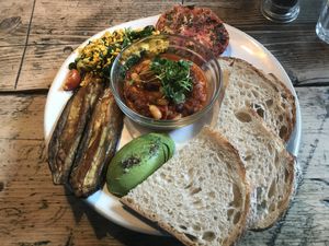 Vegan breakfast with tofu scramble, smoky bean stew, miso eggplant, avocado, roasted tomato, and sourdough bread.  at The Old Bicycle Shop in Cambridge