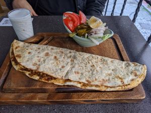 Lahmacun served with pickles and a salad at VegaNarsist - Nişantaşı in Istanbul