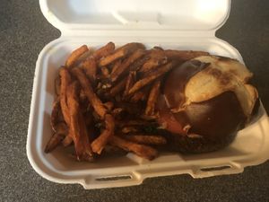 Impossible burger with sweet potato fries. Pretzel bun was a nice touch and burger held up well with take-out option. Fries didn’t hold up as well but still tasted super good! at Earth to Us  in Durham
