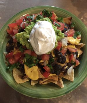 Loaded Nachos featuring a made in-house creamy, cashew nacho cheese sauce. at Earth to Us  in Durham