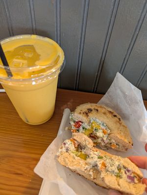 garlic bagel with special vegan vegetable cream cheese and a vegan "mango drink" which tasted like fancy mango lassi at Small Mart in New Orleans