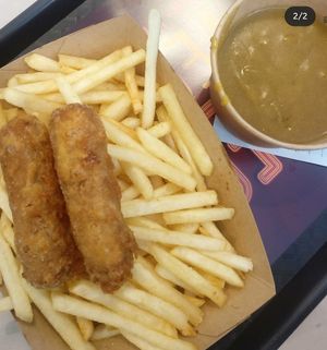Sausage and batter, chips and curry sauce  at Greazy Vegan in Cardiff