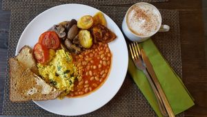 Cooked breakfast with an oat milk cappuccino  at Plantbase Cafe in South West London