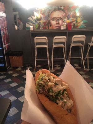 Having a cauliflower sandwich with a cool mural view  at Farm Food Ink Cafe in Lisbon