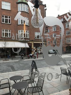 View from restaurant, with restaurant logo in window. at We Feat Pure Organic in Aalborg