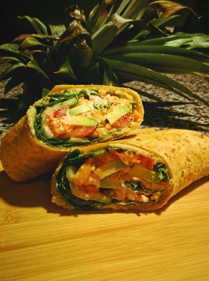 Homemade Pineapple Jalapeno Hummus, avocado, cucumber, carrots and spinach wrap. at EatQual in Cocoa