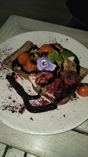 smashed avo, with cooked tomato and balsamic sauce at Nature Cafe/Bar in Frankston