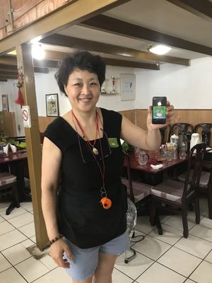 Wonderful owner - showing off her happy cow stickers   at Restaurant Pékin in Nice