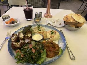 Vegan mezze platter served with Lebanese bread and bissap ( hibiscus) juice. Pickled carrots, olives and cucumber as crudite´  at Farid in Dakar