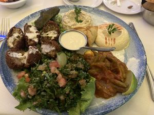 Vegan mezze platter included felafels, tabbouleh, green bean/tomato ragout, hummus, babaganoush  at Farid in Dakar