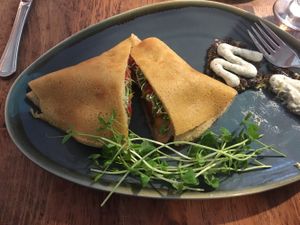 Lentil burger crepe with sprouts on the side at Kind Crepes in Mendon