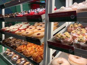 their 3 vegan flavours: red velvet, jam and chocolate with cookie dough  at Rodeo Doughnuts - Shaftesbury Ave in London