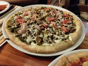 This is incredible! Pesto, crumbled almonds, red onion, tomatoes, and added vegan cheese. at Coogi's Restaurant in Mdina