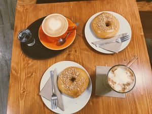 Latte, 2 salted peanut doughnuts and an iced latte  at Vegan Food & Sweet Bar in Brno
