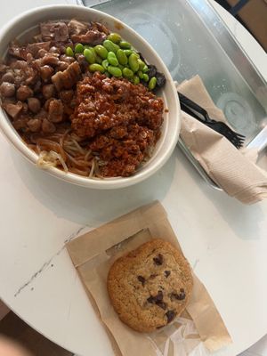 My meal: regular build your own bowl with edamame boost, vegan chorizo, vegan chickpea medley, and a base of sweet potato noodles and quinoa. Vegan chocolate chip cookie on side at Vale Food in Gainesville