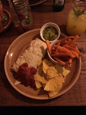 Vegan burrito with vegan cheese, salsa, guacamole, sweet potato fries and nachos! Yum! at Rangos in Winsford