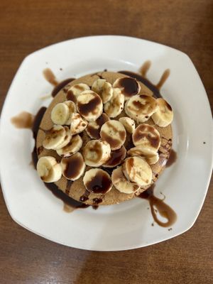 Vegan pancakes with coco and banana. Made with wheat flour. Came with syrup on the side. Super yummy!  at Carmita's Pancake House Restaurant in Montanita