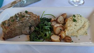 "surf and turf" vegan meatloaf made with impossible meat, and king oyster mushrooms with cauliflower mash and greens at Skopelos in Pensacola