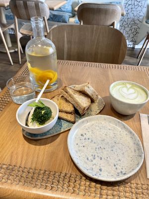 Sourdough bread and nuts burrata. Matcha latte and complimentary water    at My Mother's Daughters  in Lisbon