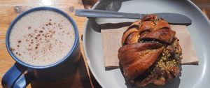 Oat milk latte & cinnamon roll at Orchard Lane Coffee House in Folkestone