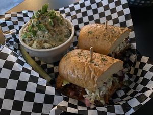 BBQ Pulled Pork Sandwich with a side of potato salad at Georgetown Liquor Company in Seattle