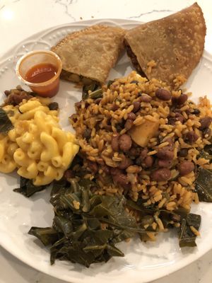 Habichuelas, rice w/ gandules, collards, mac & cheez. With a chickpea curry empanada   at Vegan International Co in Tampa