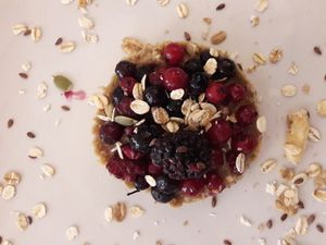 Delicious vegan breakfast! Oat flakes with oat milk with plentyful berries and chia seeds at Amaranta Biobar in Valencia