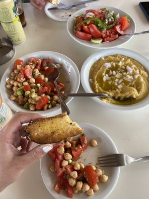Complimentary bread, chickpea salad, Greek salad, and fava (split pea dip). at Taverna Kalyva in Crete