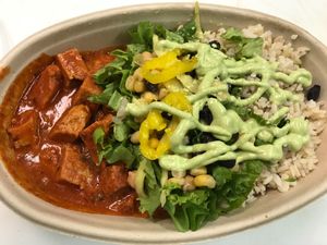 Mmm Butter Chick'n Buddha Bowl with Brown Rice, Greens, black beans and a drizzle of sauces!  at Vegorama in Ypsilanti