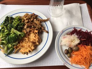 Seitan, brocoli, spinach, onion bhaji and crudités on the side at A Colmeia in Lisbon