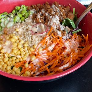 Korean BBQ rice bowl (subbed with 1/2 spinach). Edamame, soyaki carrot, sesame radish, chickpea crunch, and ginger aioli. So good and filling!  at Old Abe & Co. in Rochester