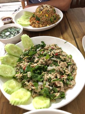 Delicious! Spicy vegan larb and an order of fried rice in the back. at Kuan Im Yok in Vientiane