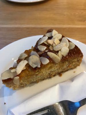 Vegan apple and banana cake topped with apricot glaze and crystallised almonds  at Loudons Cafe and Bakery - Fountainbridge in Edinburgh