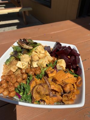 Made my own bowl!! Really good! Kale,quinoa, roasted chickpeas, roasted sweet potatoes, roasted Brussels , tofu, roasted beets with a vinaigrette dressing at Enlightened Cafe in Ventnor
