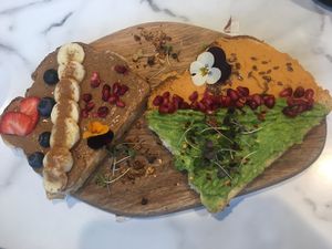 Toast two ways: smashed avo, spicy hummus, almond butter, blueberries, banana at POG - Bachelor's Walk in Dublin