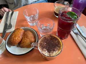 Cappuccino, pain au chocolates and drink with hibiscus  at Aujourd'hui Demain Cafe in Paris